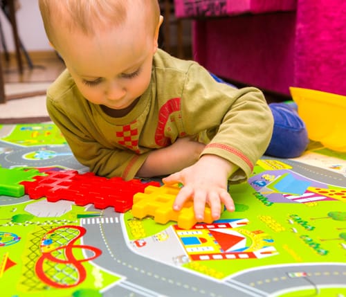 Toddler Playing with Plastic Blocks