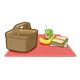 Picnic with a basket, banana, juice, and sandwich